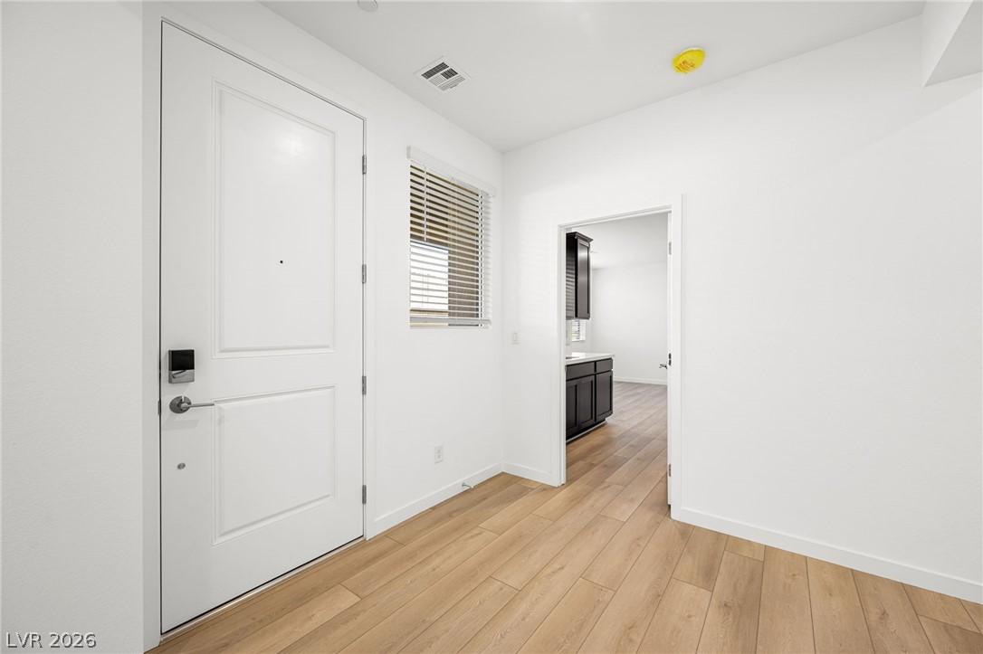 Image 2: A welcoming entry, complete with hardwood flooring