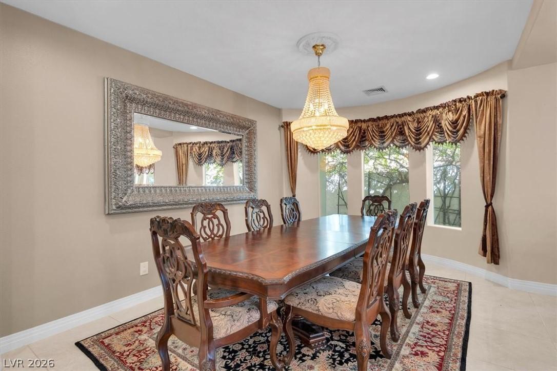 Image 4: A grand chandelier illuminates this refined dining
