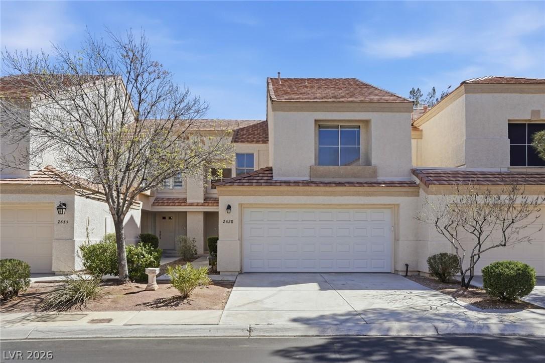 Image 2: View of front of house featuring stucco siding, dr