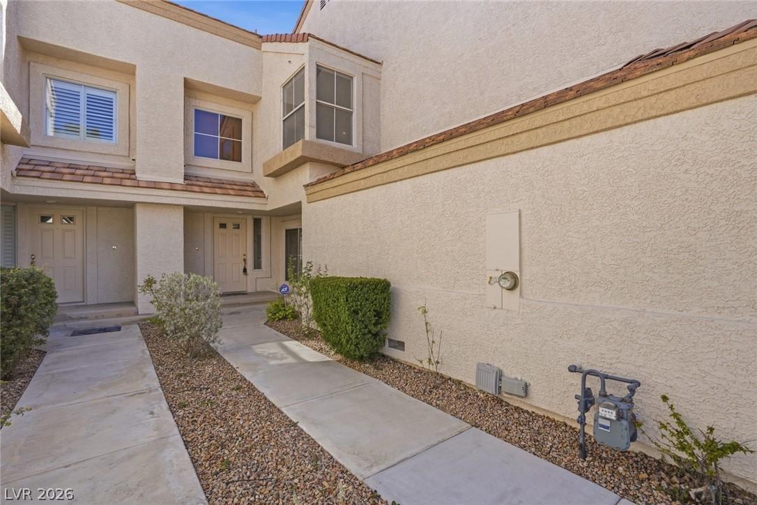 Image 4: View of exterior entry with stucco siding