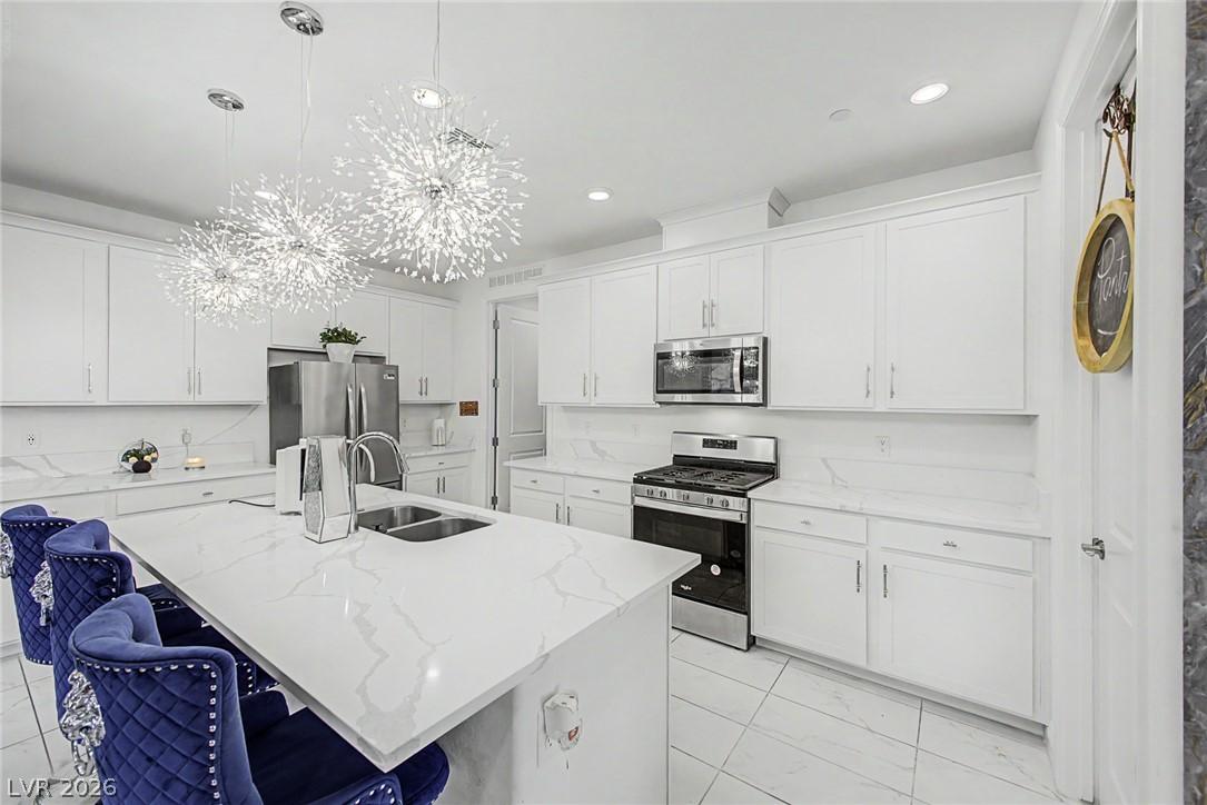 Image 3: A well-appointed kitchen features a large center i