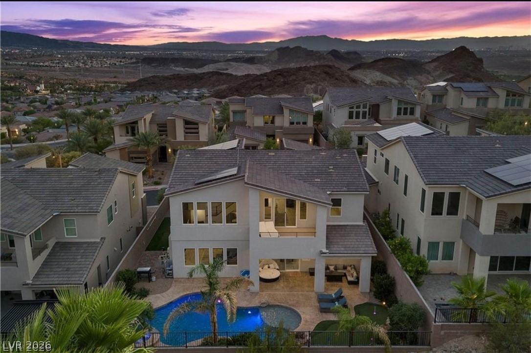 Image 2: Aerial shot of back of the home and mountain views