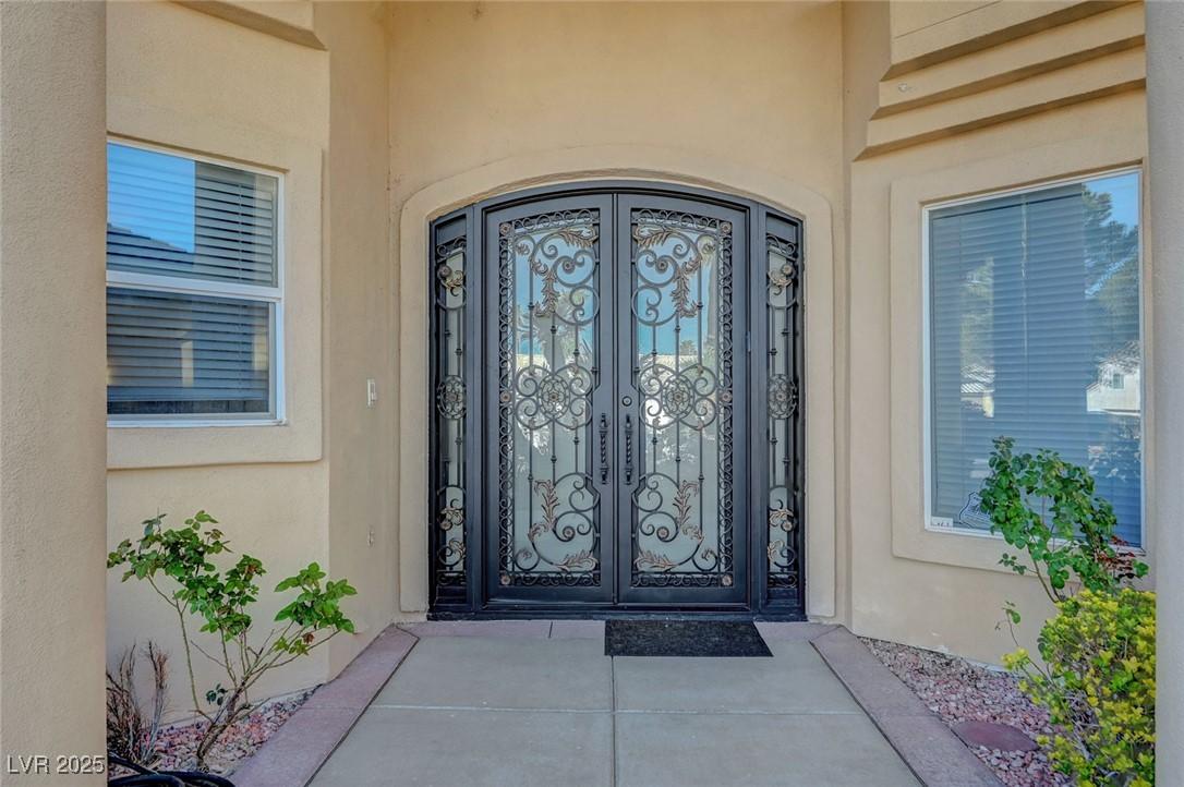 Image 4: Doorway to property featuring stucco siding and fr