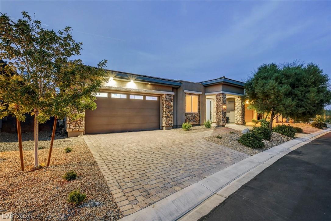 Image 1: This modern home features a paved driveway and sto