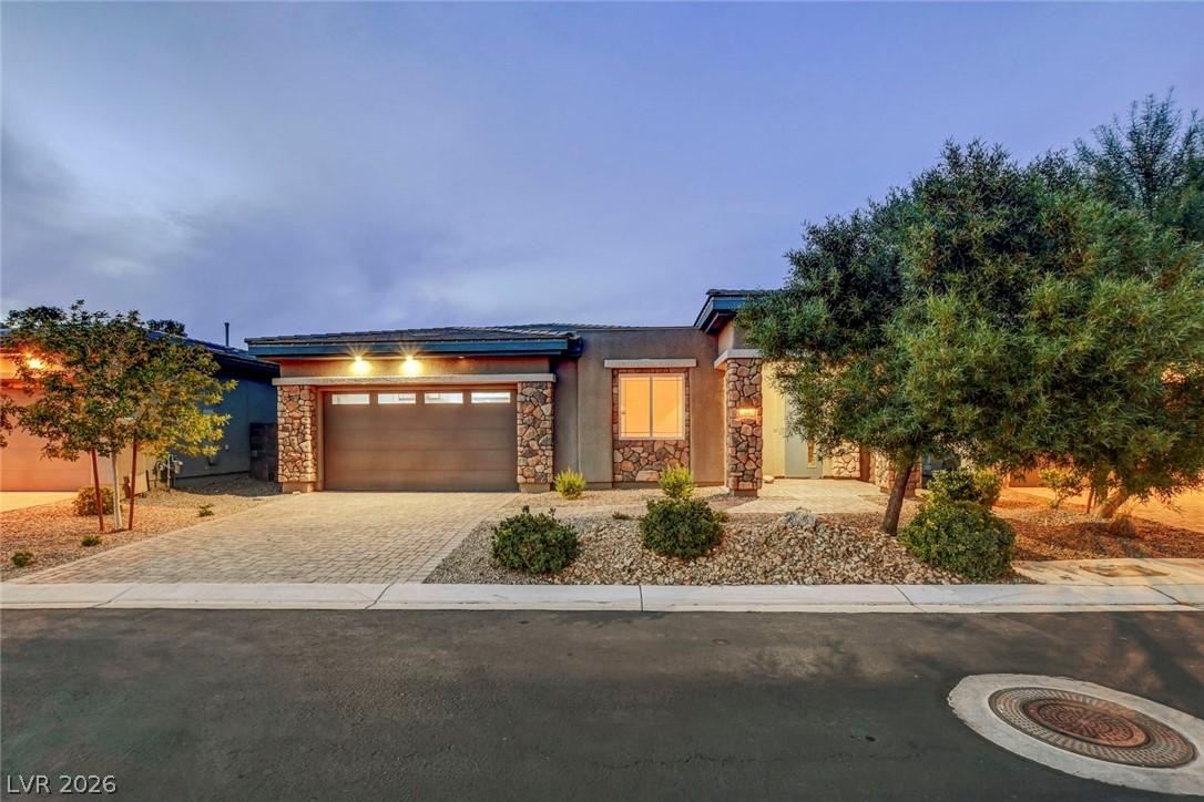 Image 2: This inviting home features a beautiful stone and