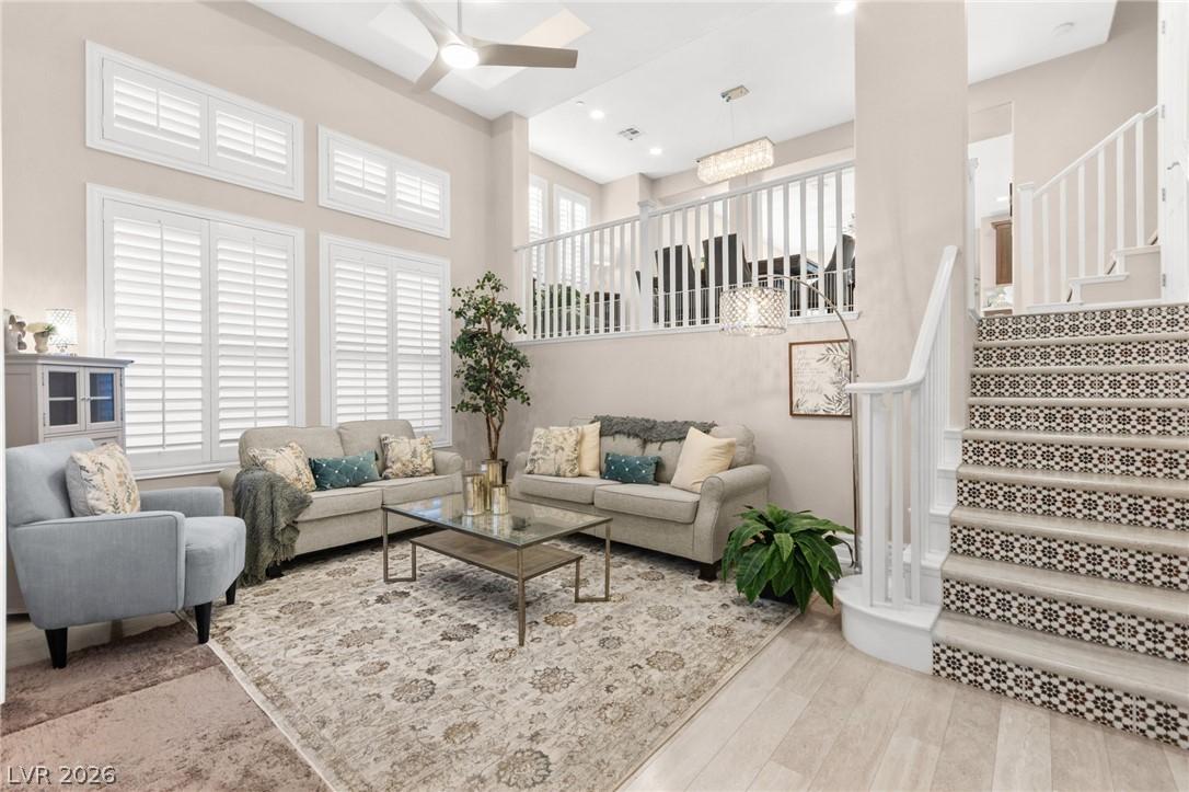 Image 2: Sun-filled living space with lofty ceilings and a