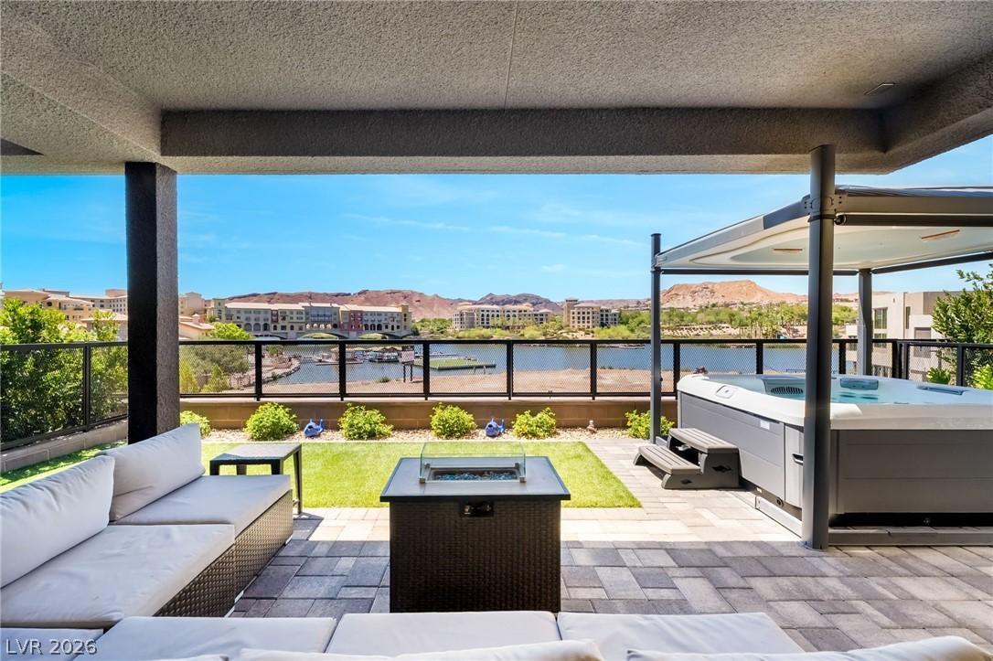 Image 1: A spacious covered patio offers a private spa and