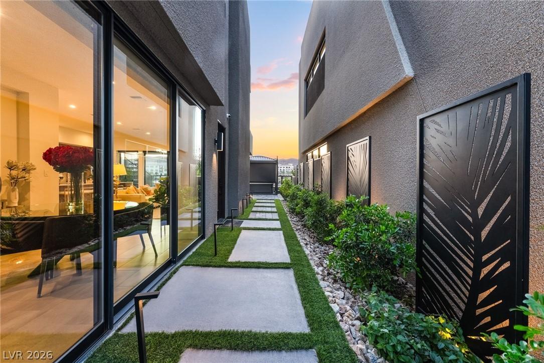 Image 3: An illuminated pathway guides to a private outdoor