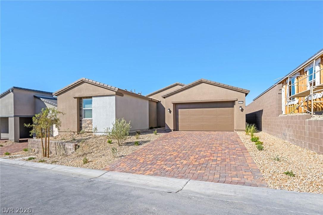 Image 2: A neatly paved brick driveway leads to this modern