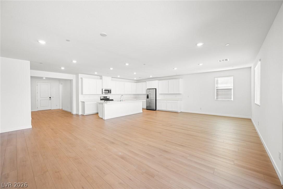 Image 3: A spacious, naturally illuminated kitchen and livi