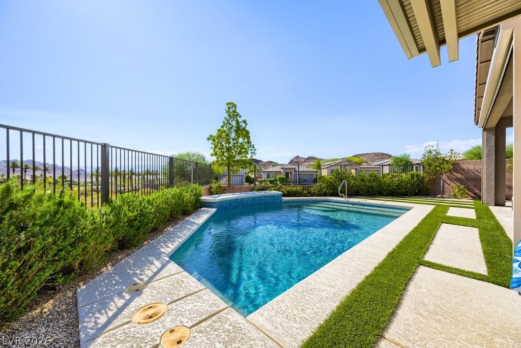 Image 2: A private, resort-style backyard oasis features a