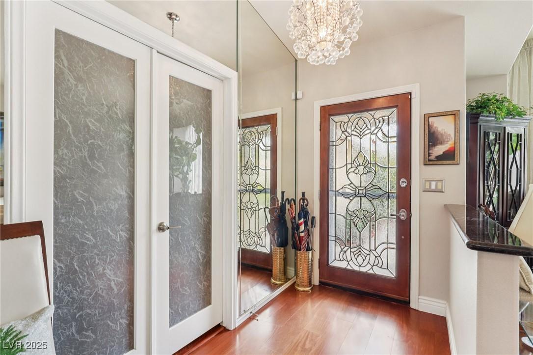 Image 4: Entrance foyer featuring french doors, a chandelie