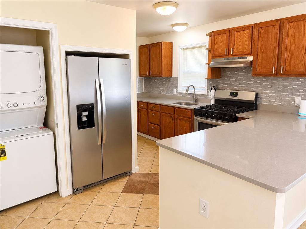Image 2: Well-appointed kitchen featuring sleek countertops