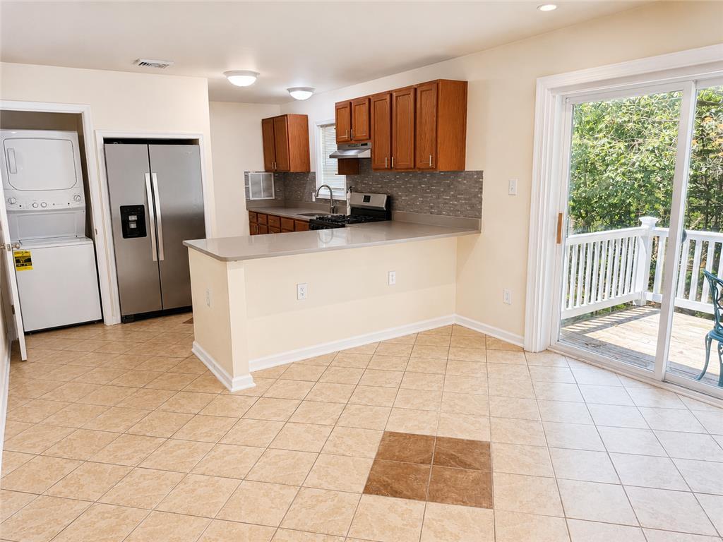 Image 4: An open-concept kitchen and dining space with acce
