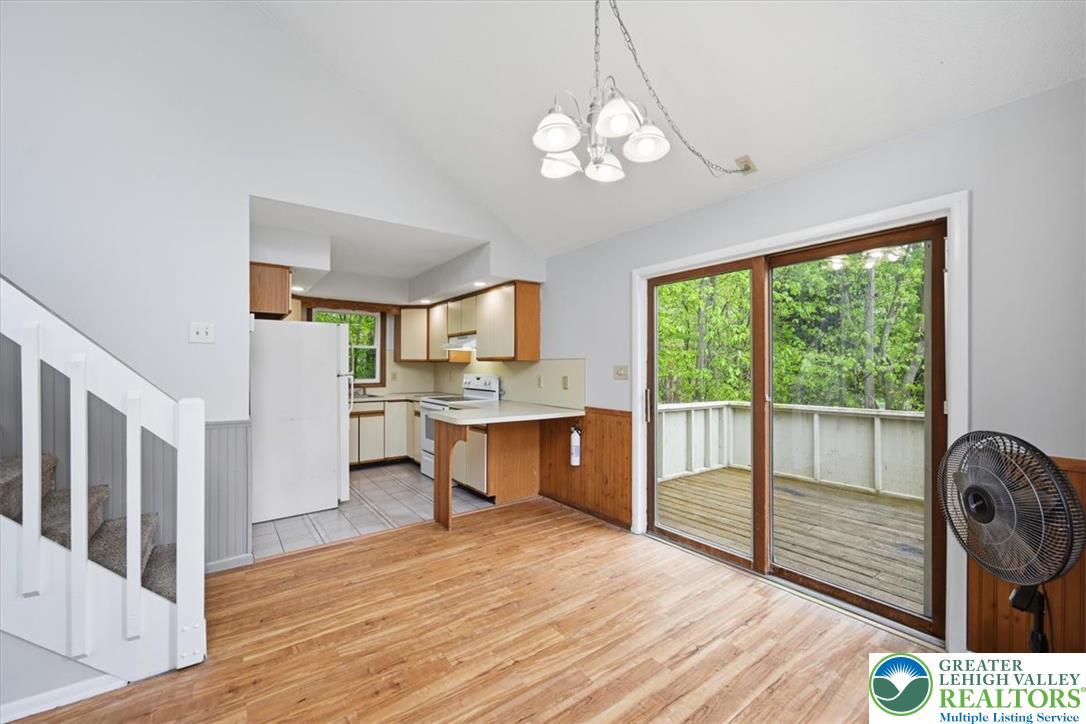 Image 3: A well-lit kitchen and dining area transitions sea