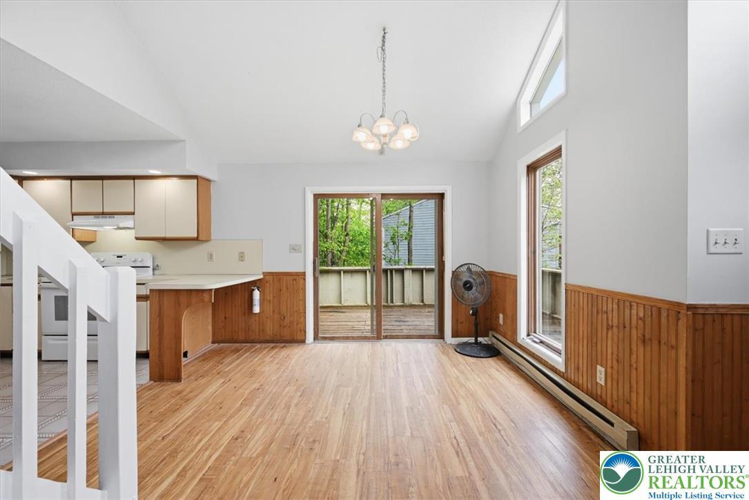 Image 4: A combined kitchen and dining space with natural l