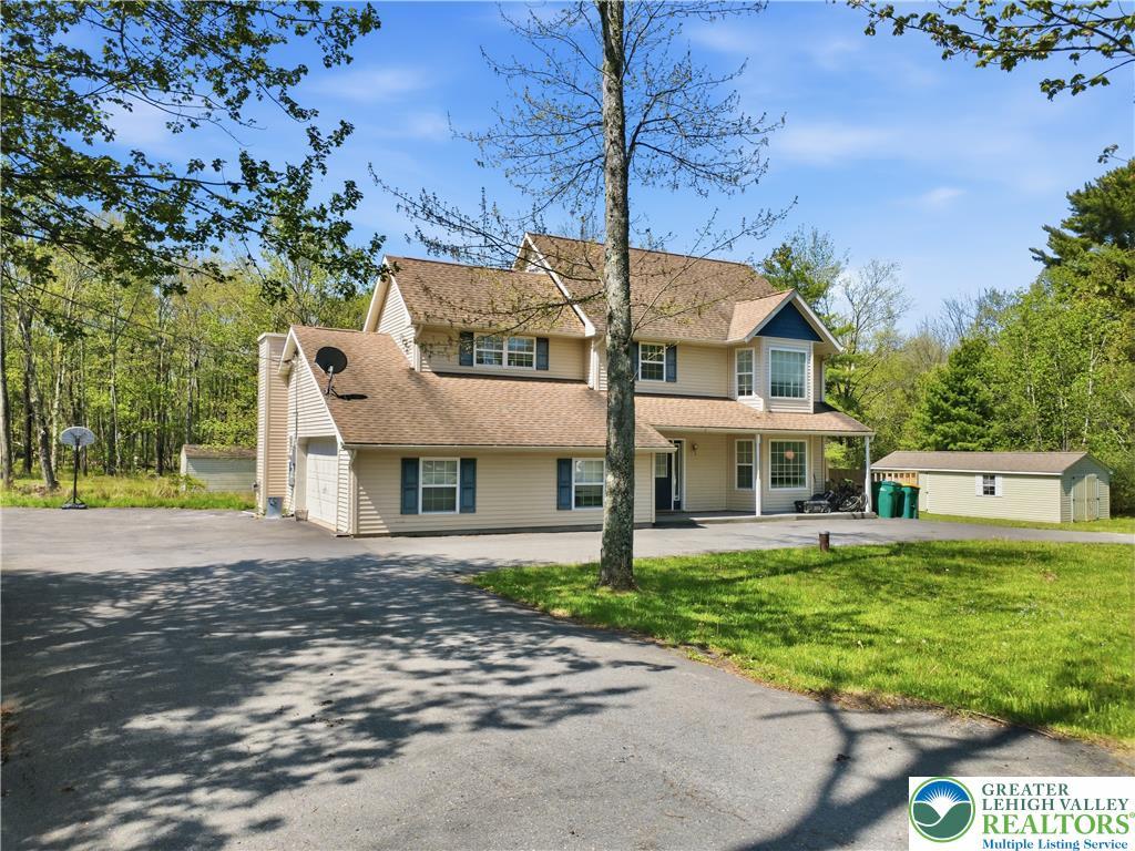 Image 2: A classic two-story home with an attached garage a