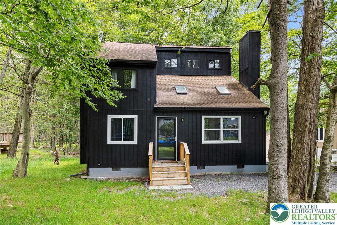 Image 1: A dark-clad forest retreat awaits, nestled among v