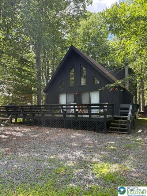 Image 1: Secluded A-frame nestled amidst towering trees, fe