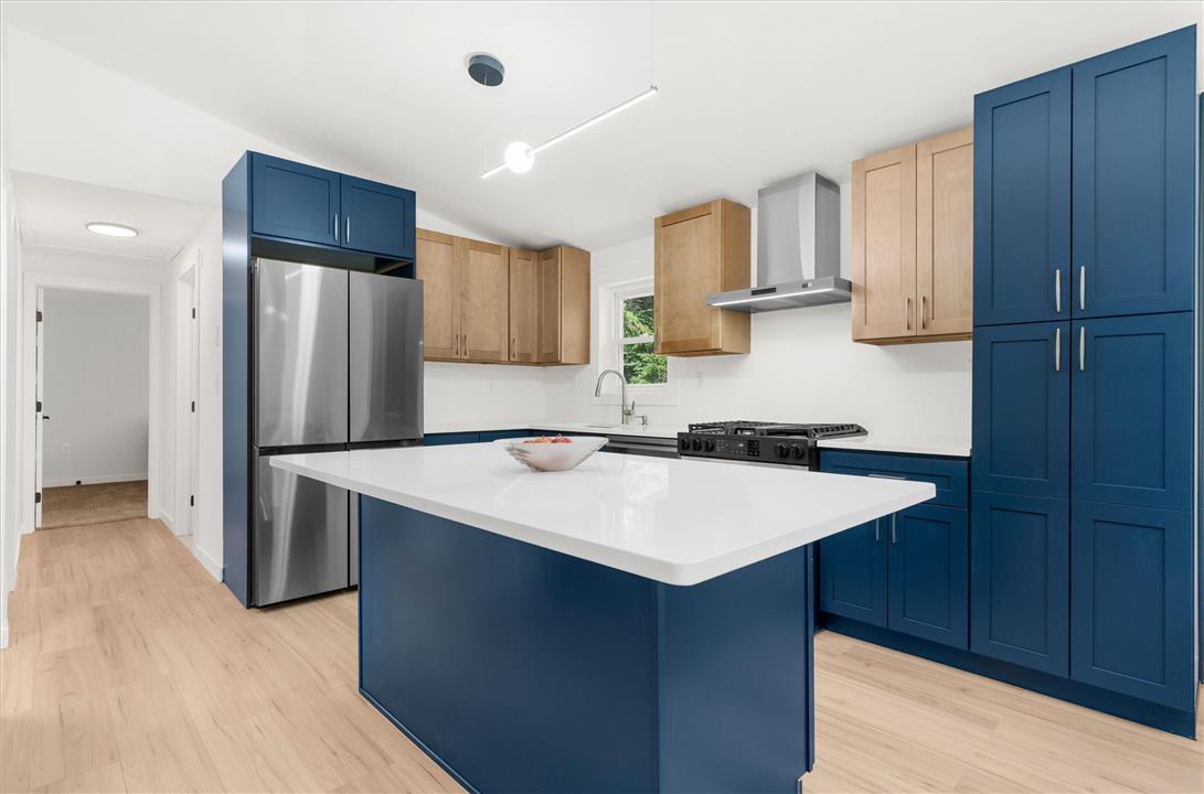 Image 2: A contemporary kitchen features a sleek island and