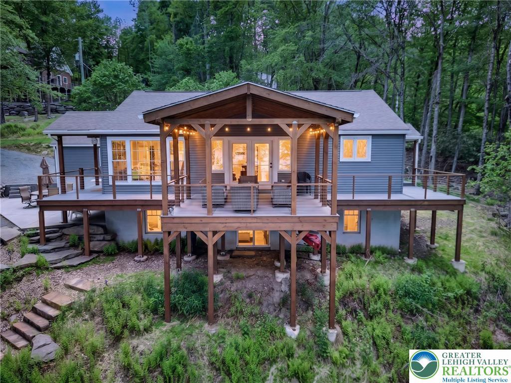 Image 1: Wooded lot with an inviting elevated deck for outd