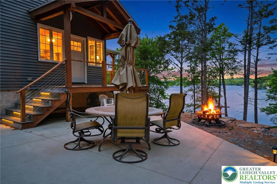 Image 2: A tranquil lake view from the illuminated patio, c