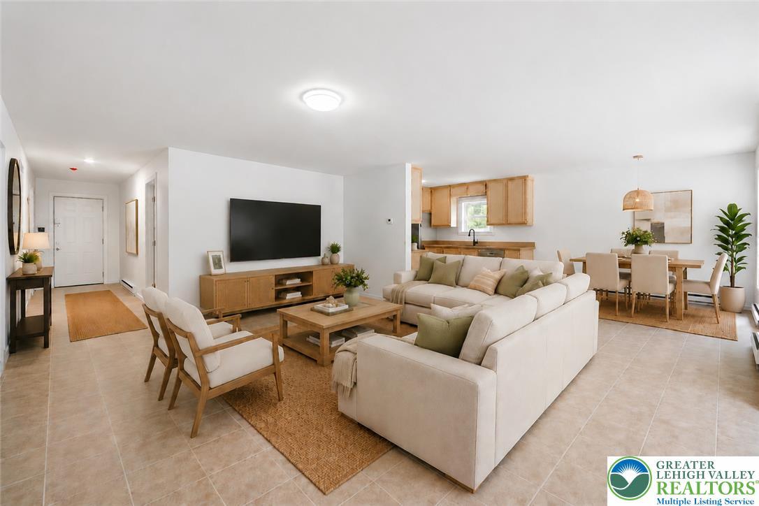 Image 3: An inviting open-concept living space features a s