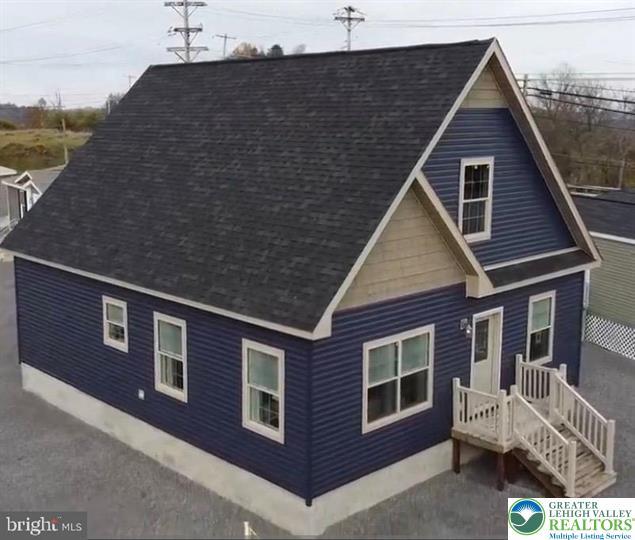Image 2: A striking blue facade with contrasting trim creat