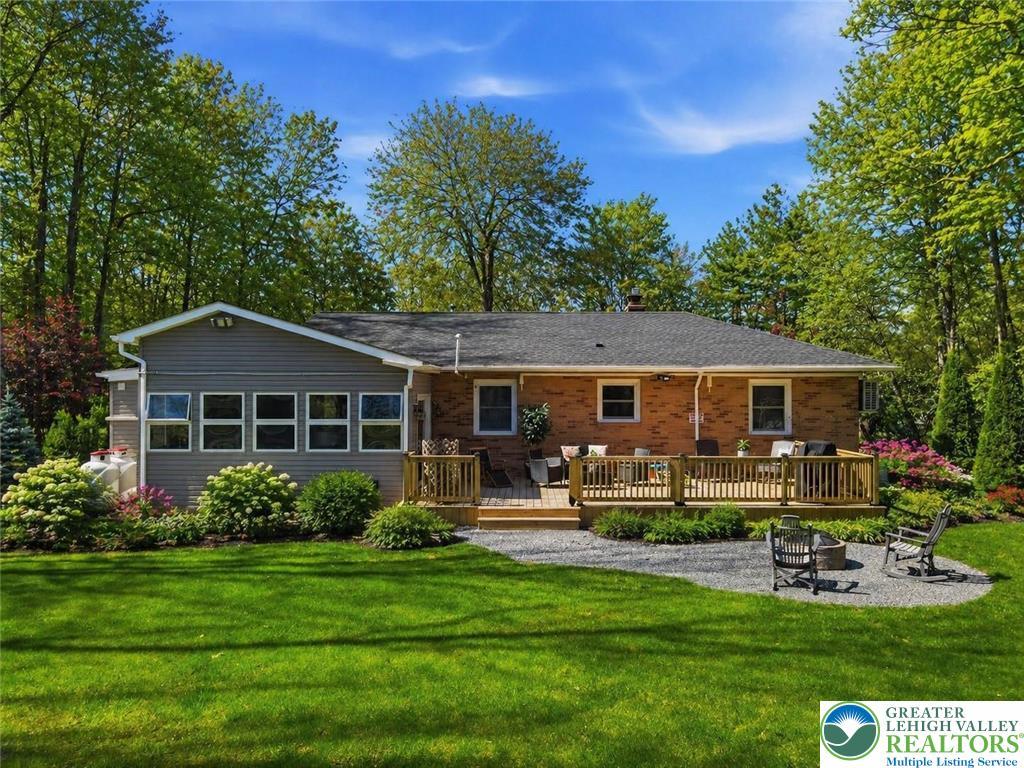 Image 4: This outdoor oasis offers a spacious deck and fire