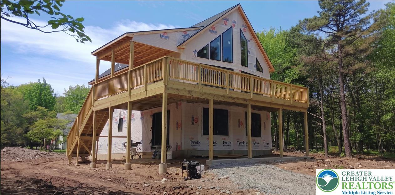 Image 2: A newly constructed modern home emerges from a nat