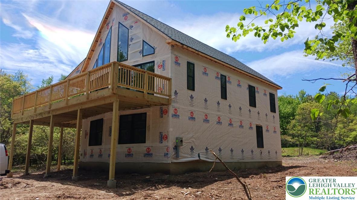 Image 3: A new construction home with an elevated deck prov