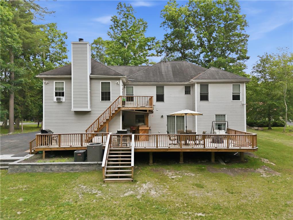 Image 4: A spacious wood deck extends from the rear, provid