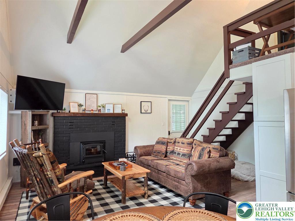 Image 3: A cozy gathering area features a brick  wood burni
