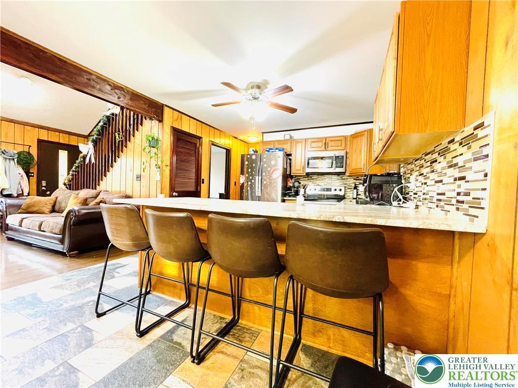 Image 3: Granite countertop with additional seating.