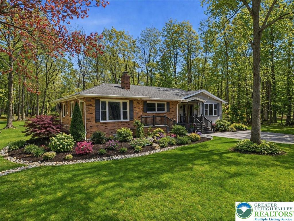 Image 2: This charming home features a well-manicured lawn