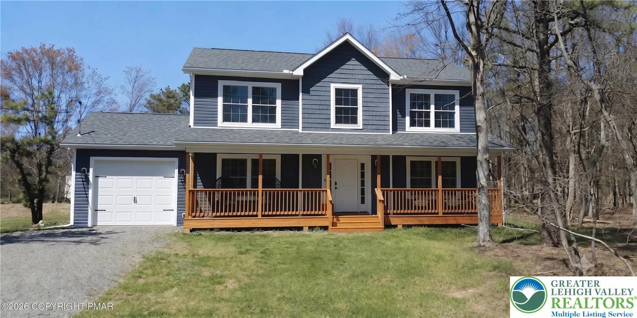 Image 1: Welcoming front porch and an attached garage, nest