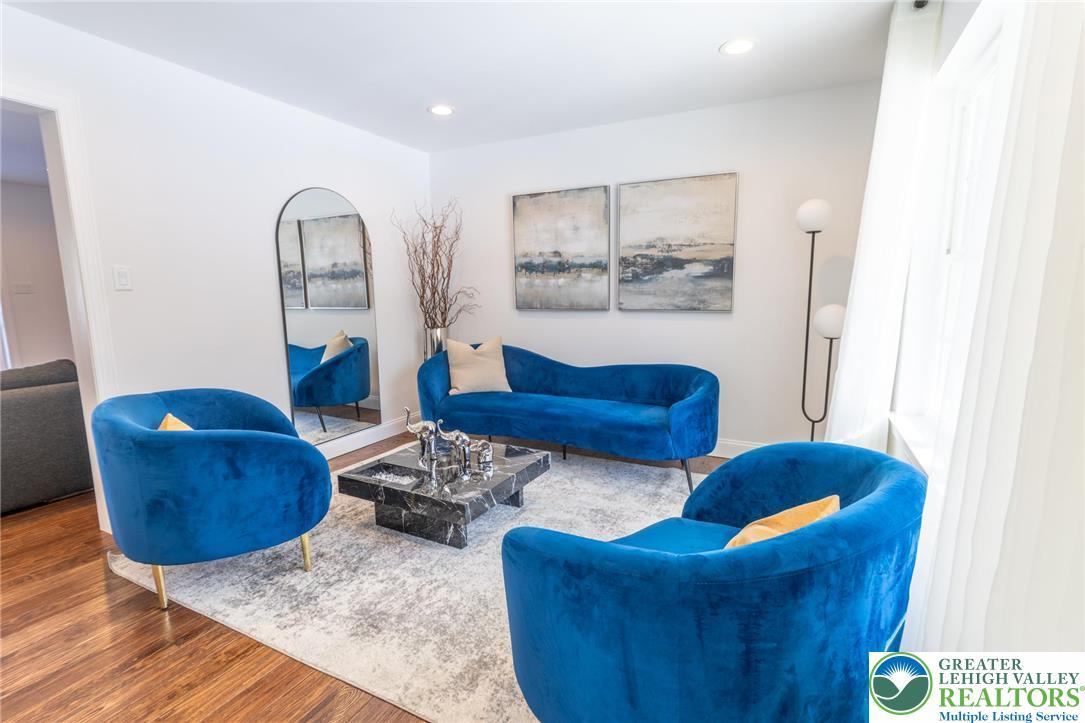 Image 4: This living room features rich wood flooring, cris