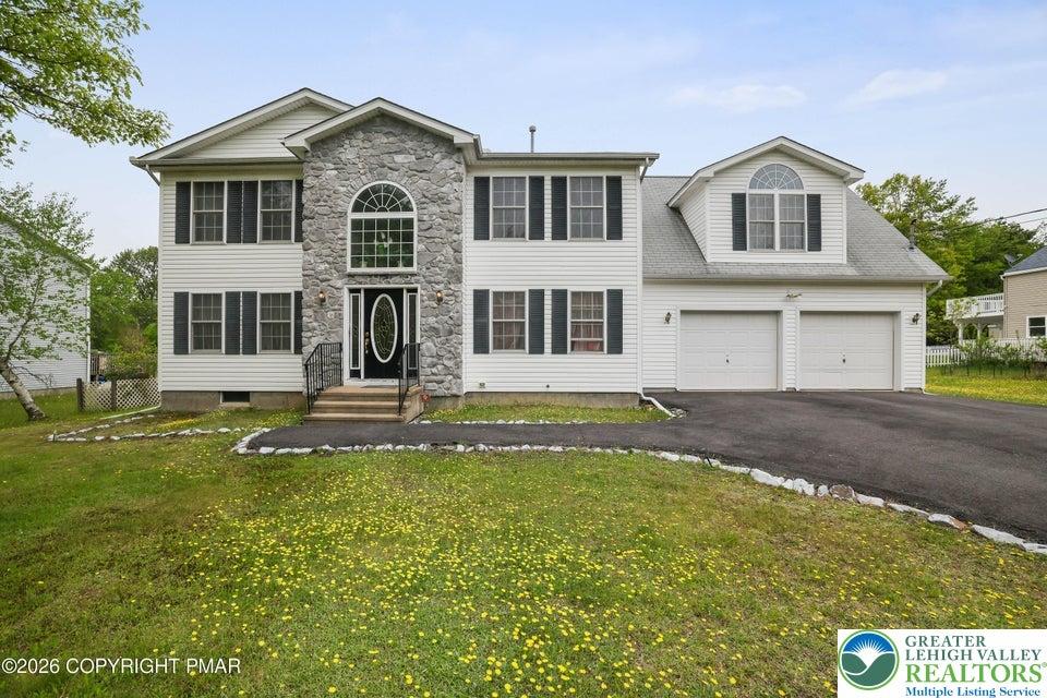 Image 1: A classic facade combining stone and siding create