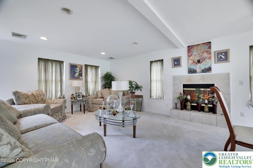 Image 2: Recessed lighting illuminates a comfortable living