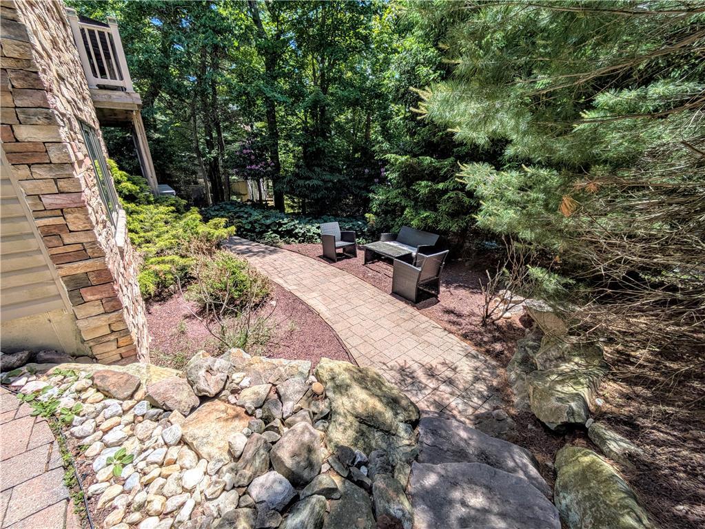 Image 4: A winding brick pathway leads to a secluded outdoo