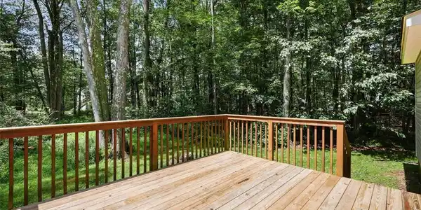 Image 2: Wood deck provides a serene outdoor retreat, seaml