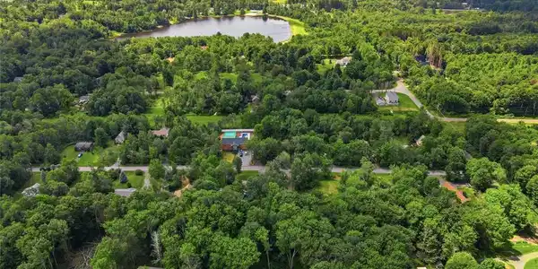 Image 4: An aerial panorama reveals a private lake nestled