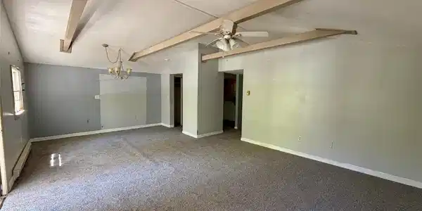 Image 2: A spacious common area with vaulted ceilings and a