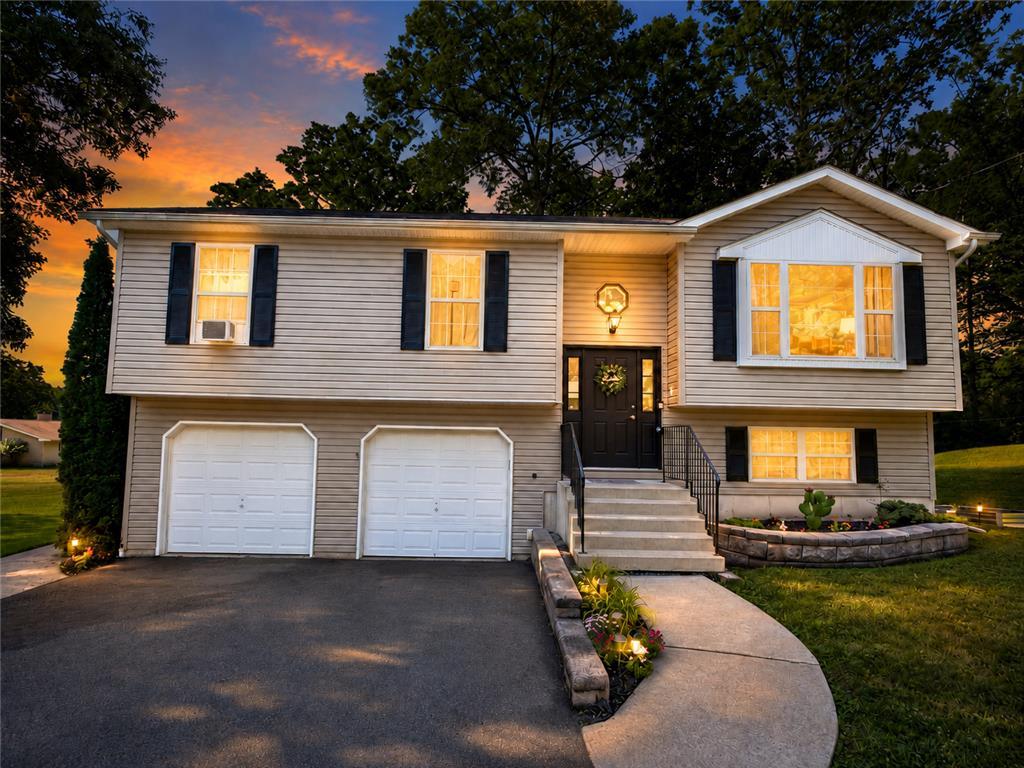 Image 1: An inviting exterior with a well-maintained yard a