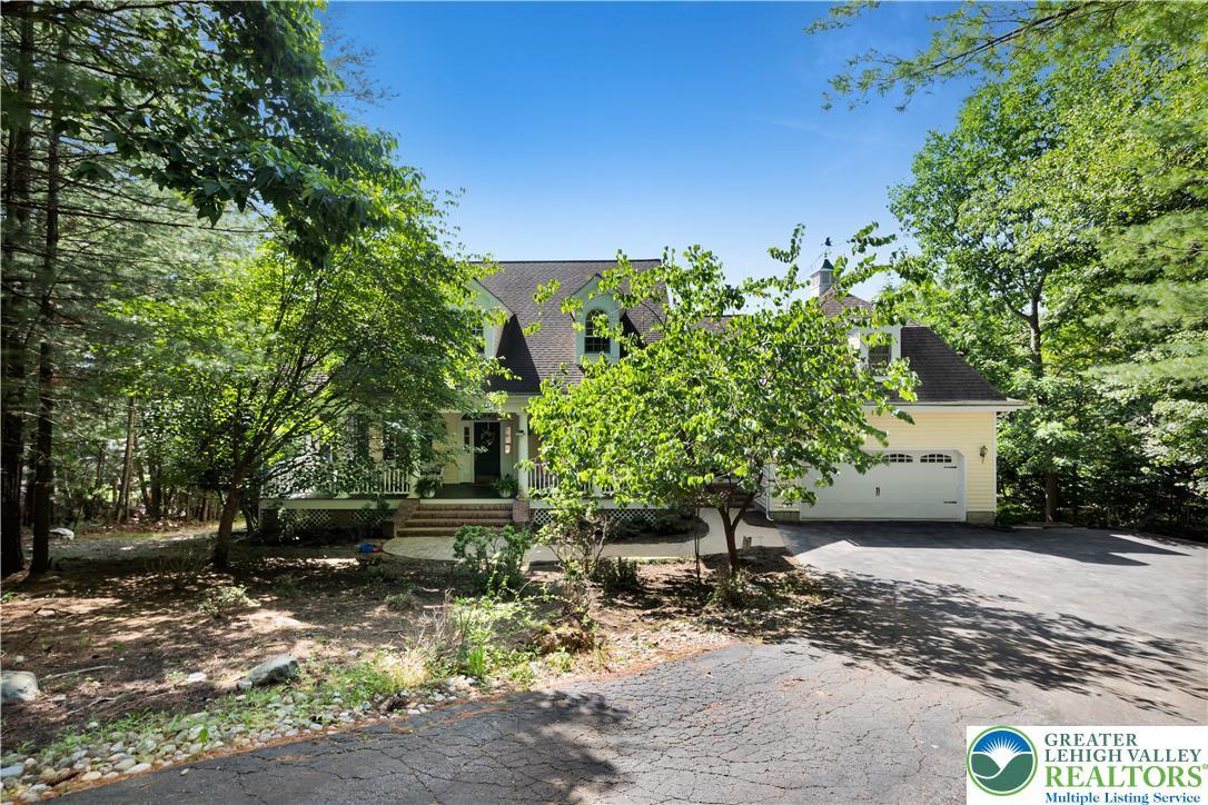 Image 2: A charming home, enveloped by lush greenery, boast