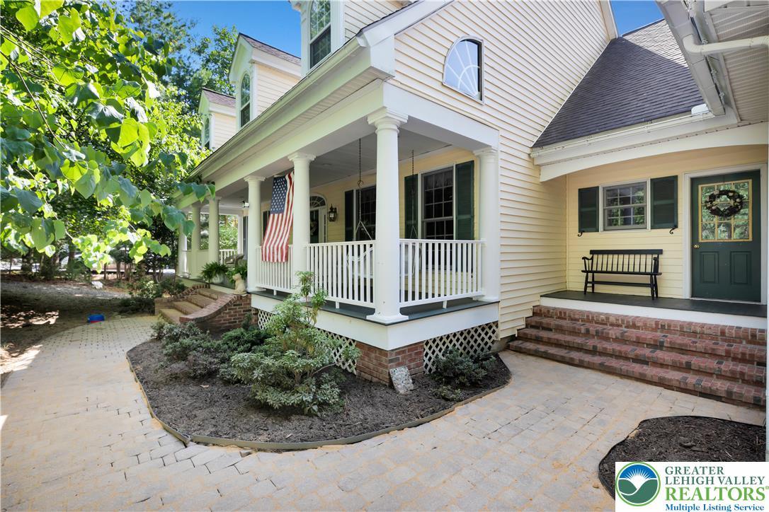 Image 3: A welcoming front porch, adorned with white column
