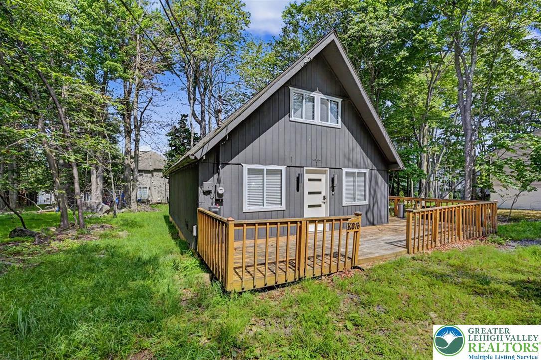 Image 3: Chalet w/ Wooden Deck. A charming A-frame cabin, n