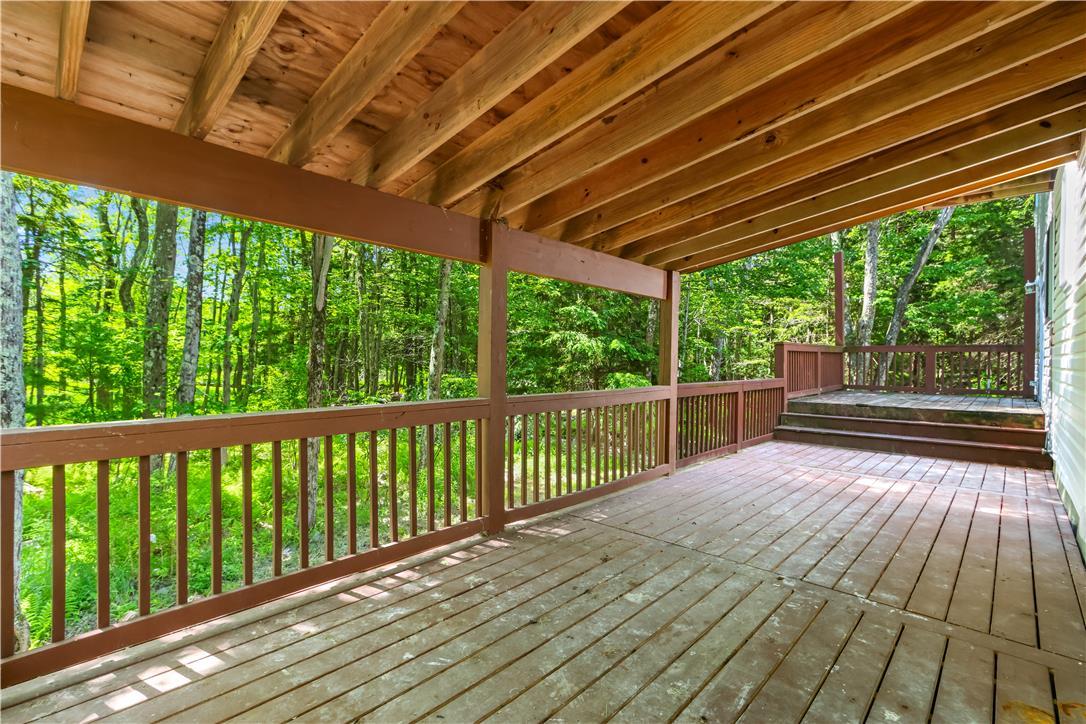 Image 2: A spacious wooden deck provides ample outdoor livi