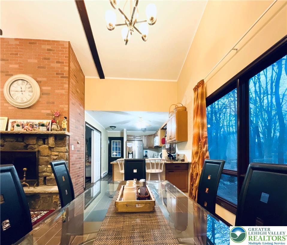 Image 4: A dining area with a high ceiling and a stunning f