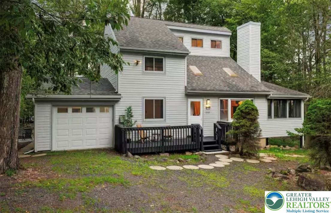 Image 1: A classic gray-sided home, featuring a prominent g